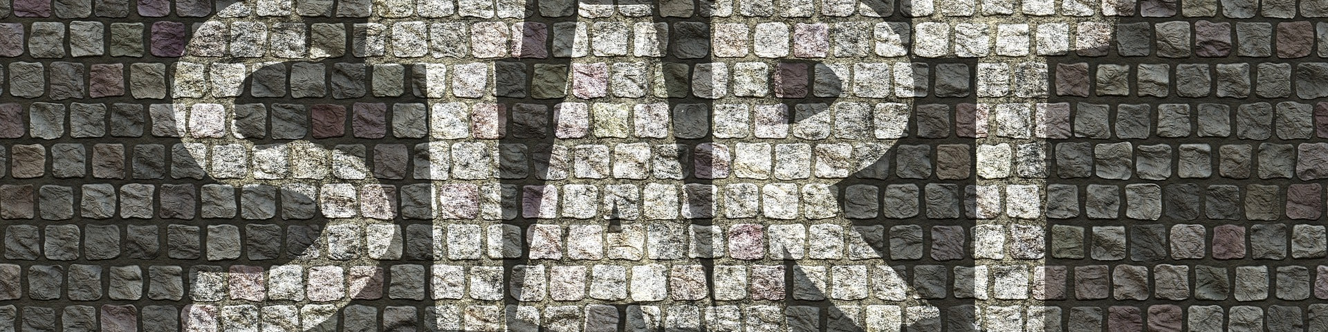 KI generiert: Das Bild zeigt eine Steinmauer, auf der das Wort "START" in großen, weißen Buchstaben zu sehen ist. Der Hauptinhalt des Bildes ist das Wort "START", das als motivierende Botschaft interpretiert werden kann.