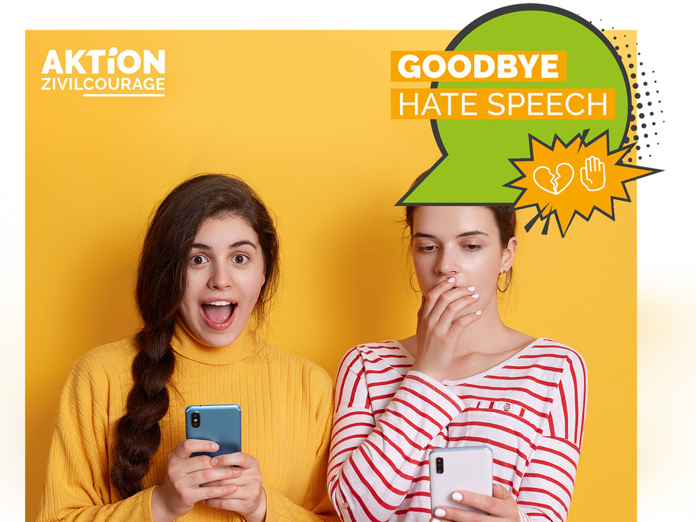 KI generiert: Das Bild zeigt eine Person, die eine Tasse mit der Aufschrift "Goodbye Hate Speech" und einem Logo hält. Der Hintergrund ist unscharf und scheint ein Park oder eine natürliche Umgebung zu sein.